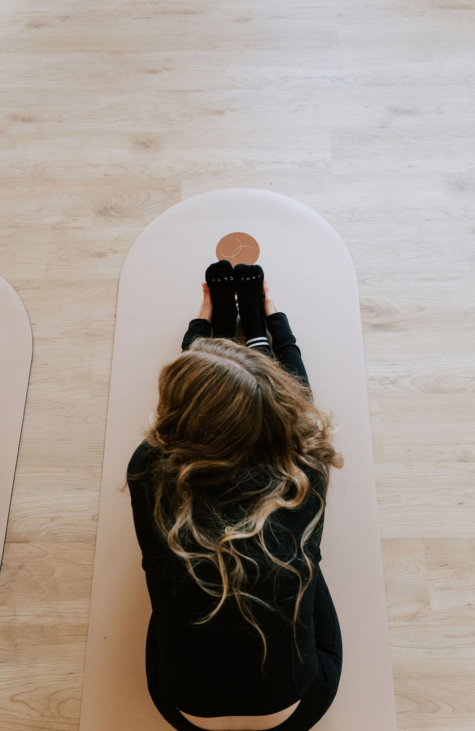 A client moving through a mat Pilates exercise on the floor
