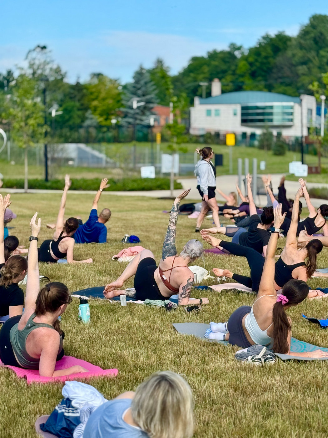 Members in an outdoor mat Pilates class at Broadway Park