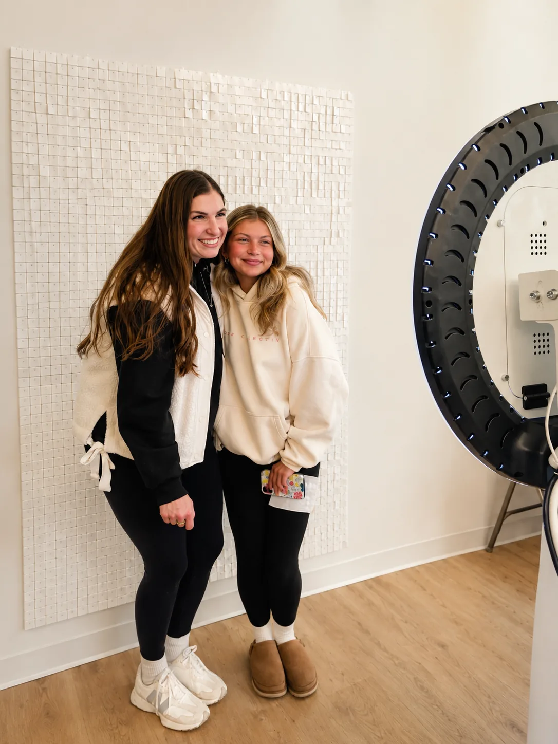 Two members posing together at a studio event