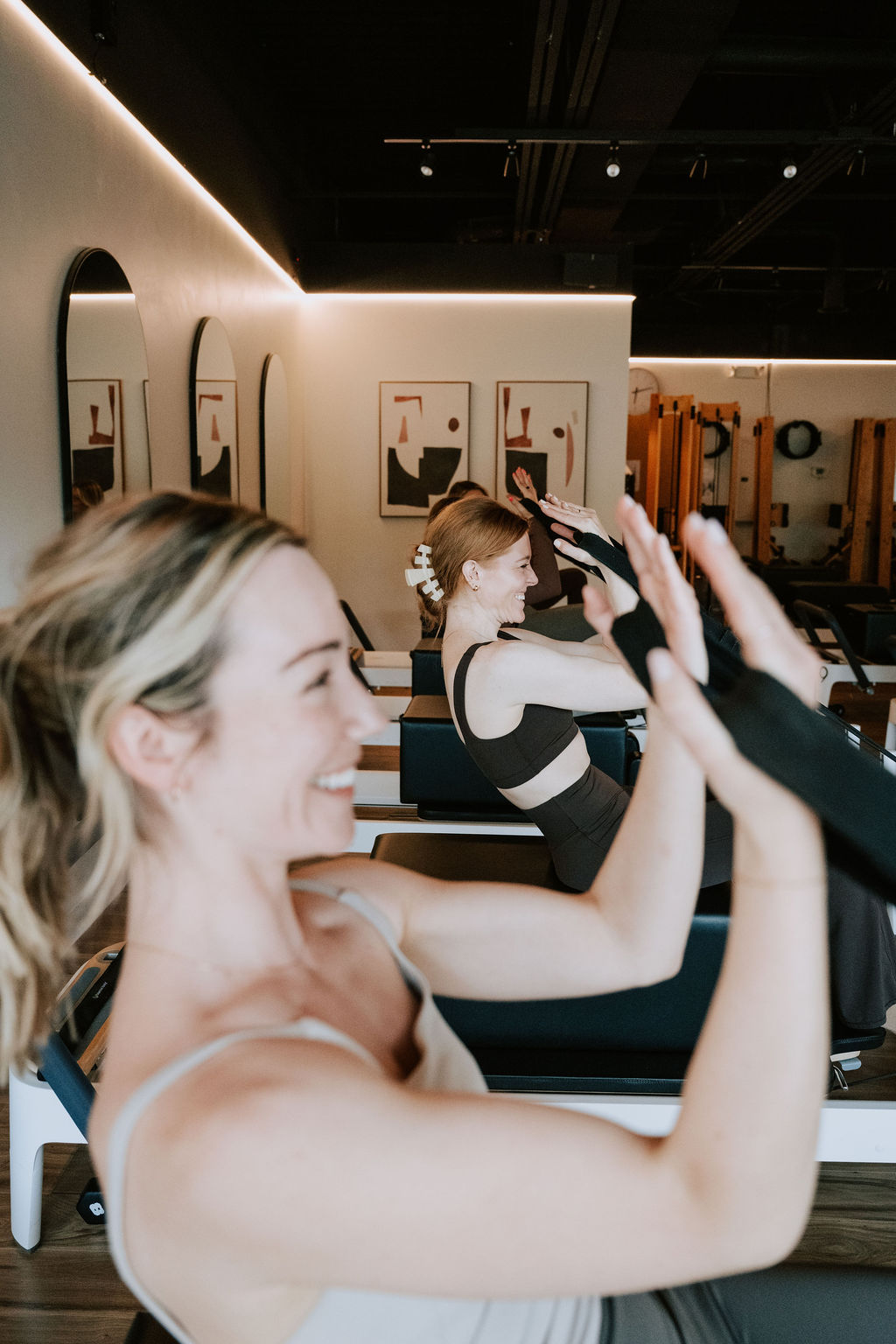 Clients smiling through a Reformer class at the Plymouth Road studio