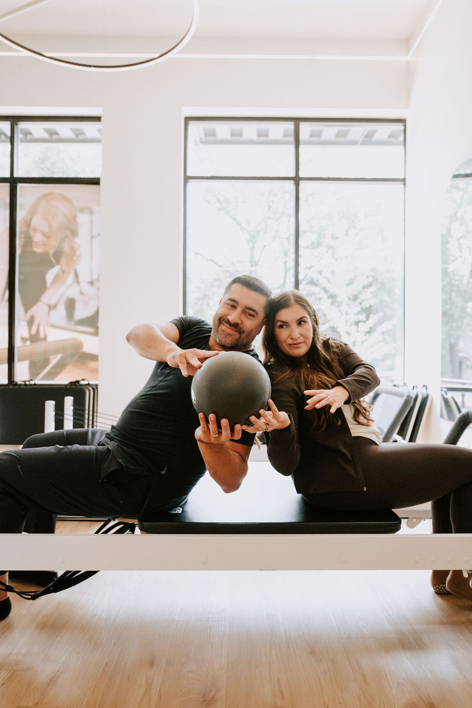 Couples taking a partner Pilates class together at Date Night