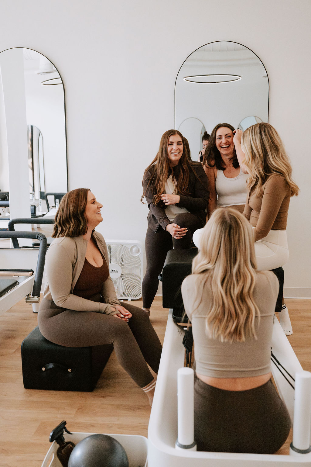 Core Collective members laughing together in the studio after class