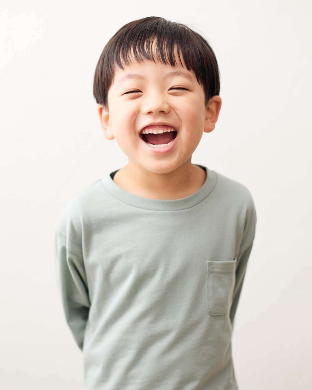 Child laughing during onsite childcare at Core Collective