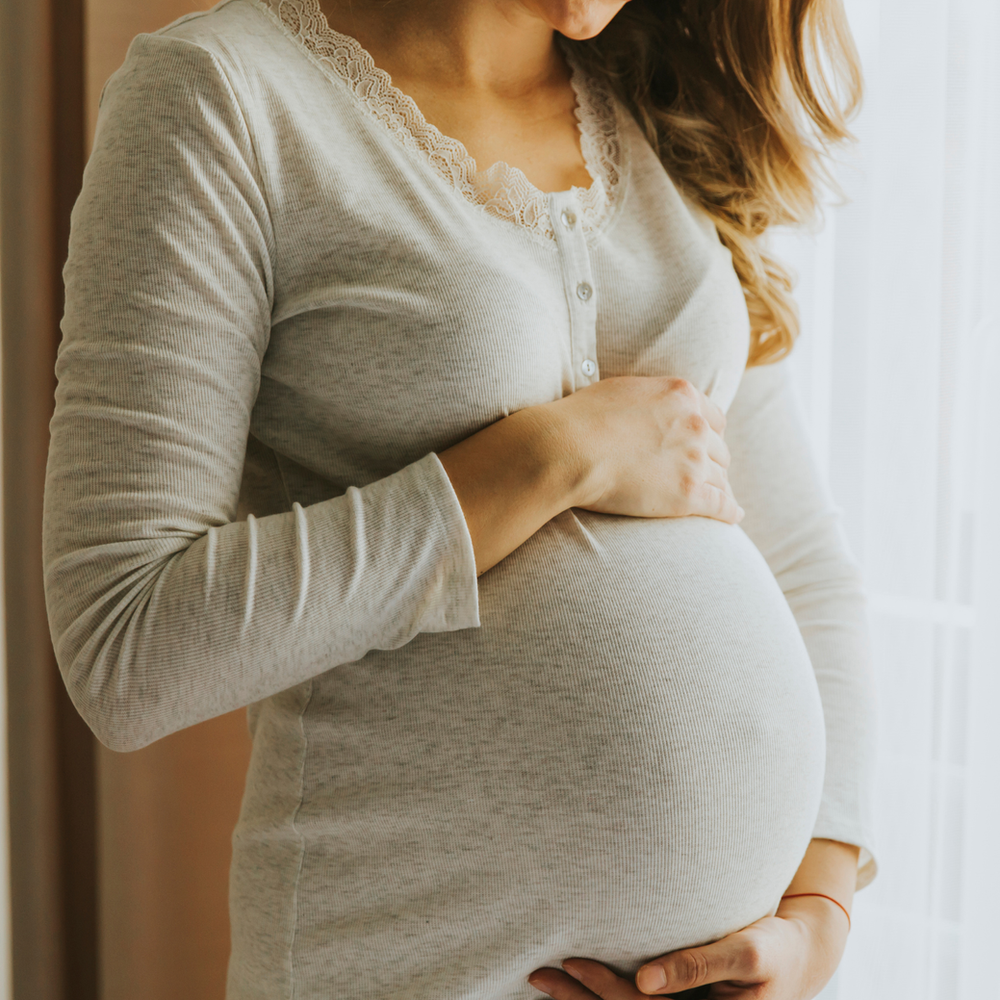 Prenatal Pilates - a pregnant client working on the Reformer